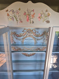 Grey curio cabinet on wheels