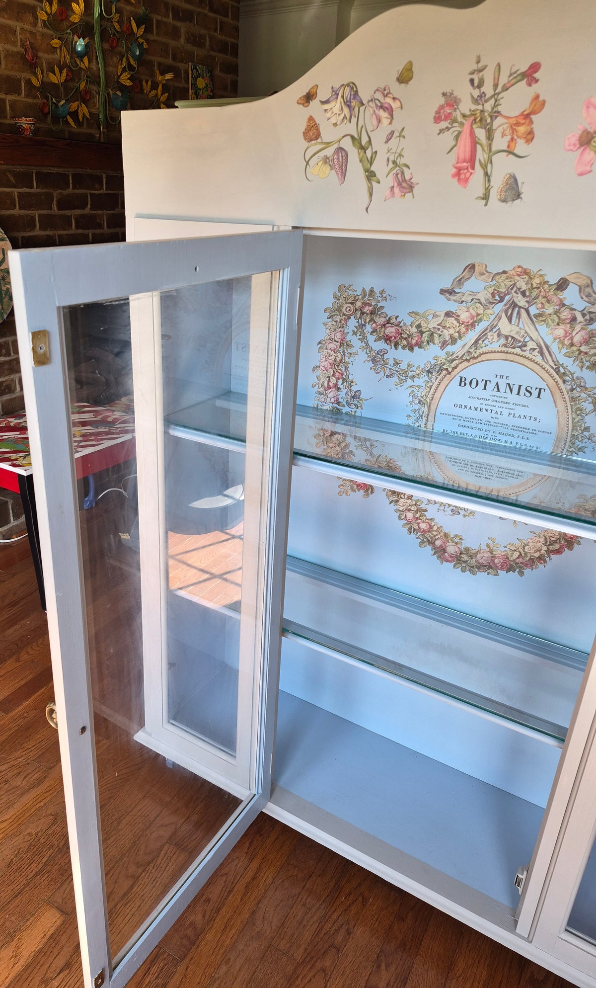 Grey curio cabinet on wheels