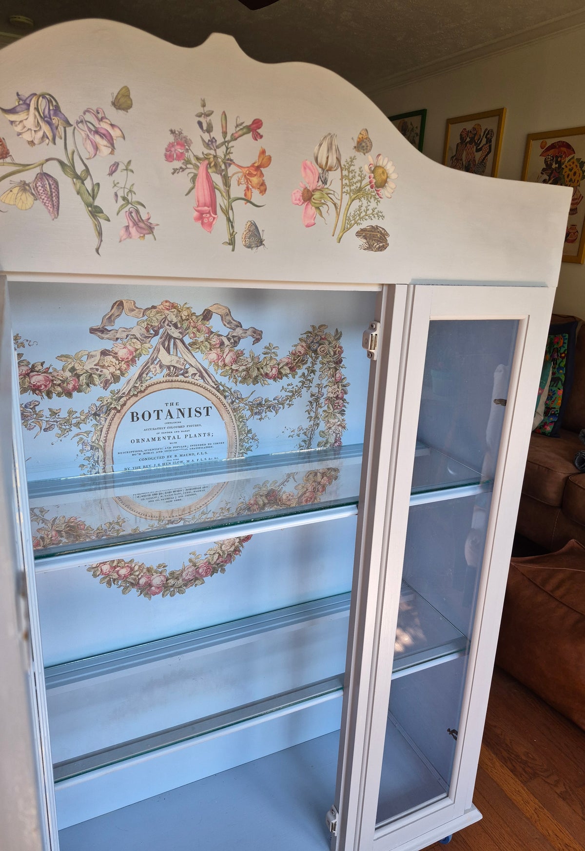 Grey curio cabinet on wheels