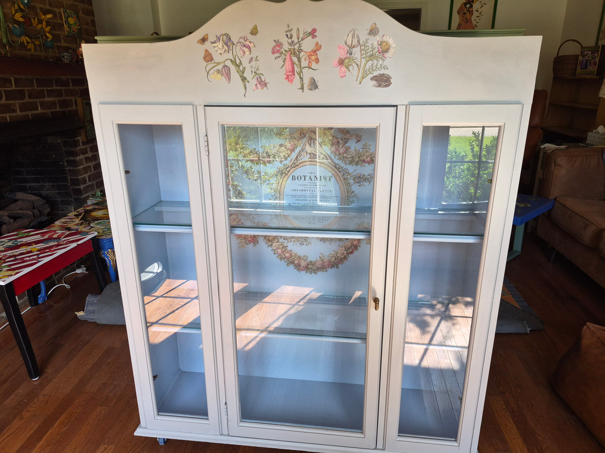 Grey curio cabinet on wheels