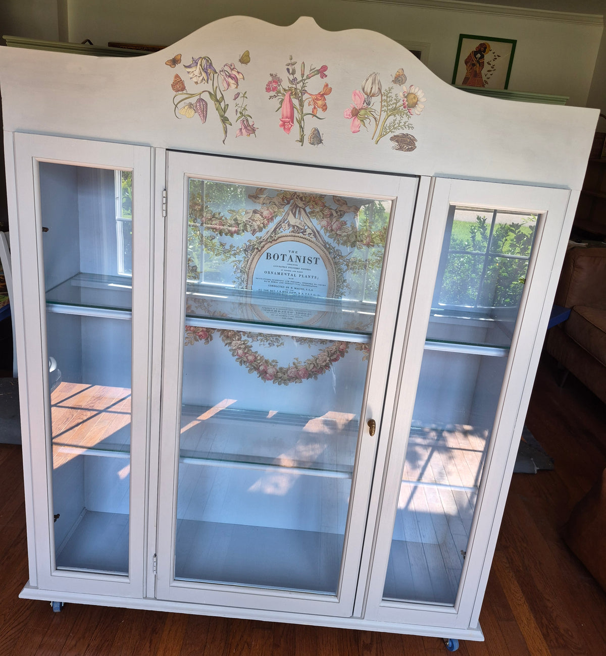 Grey curio cabinet on wheels